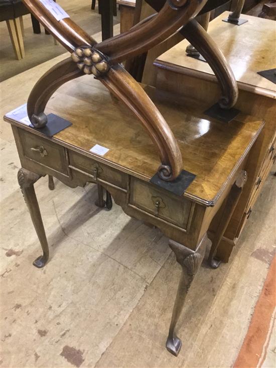 A reproduction walnut lowboy